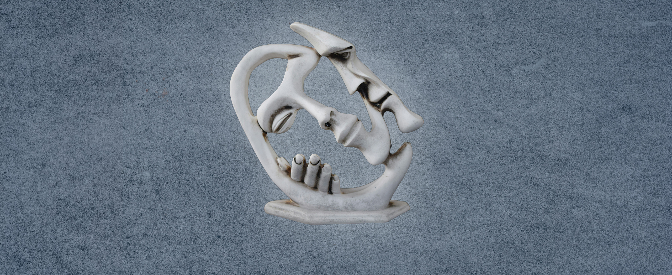 An abstract sculpture of two people in a close embrace.