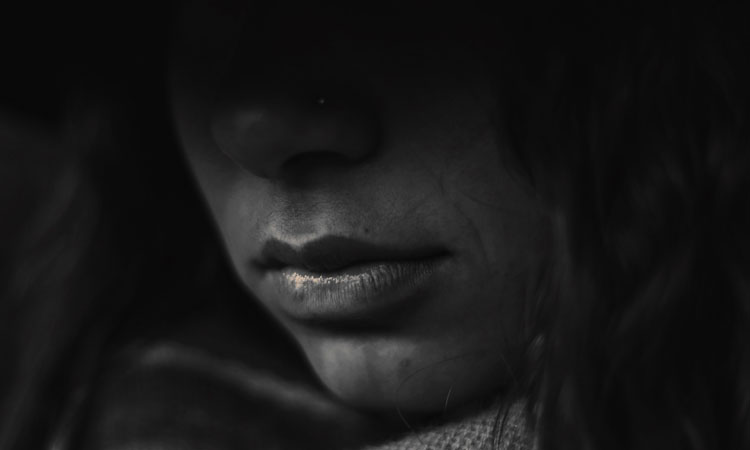 Woman's face shadowed in greyscale