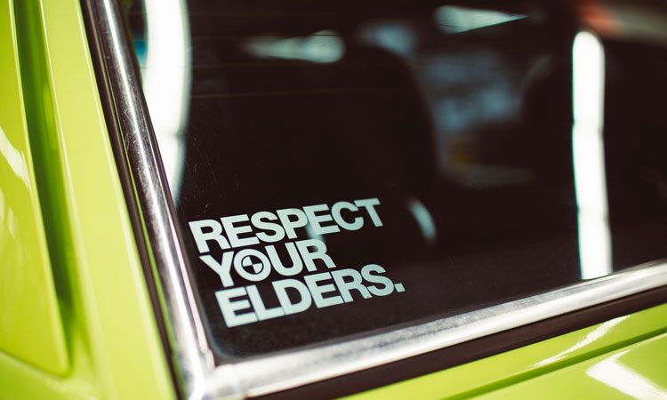 A car window sticker of the words "respect your elders"