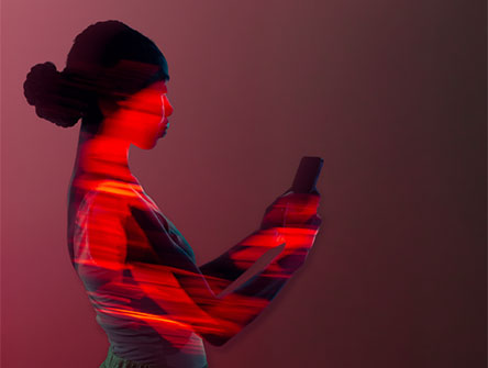 A woman looking at her smart phone.