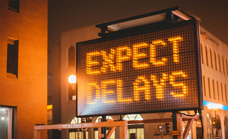 A road work sign that reads "Expect Delays". 