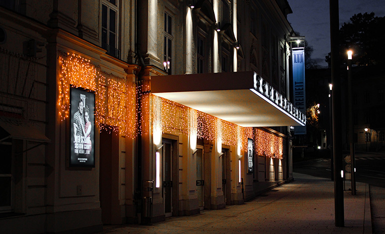 Exterior entrance to movie theatre at night