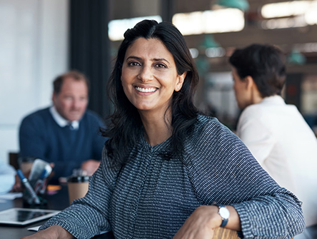 A professional woman looking directly into the camera.