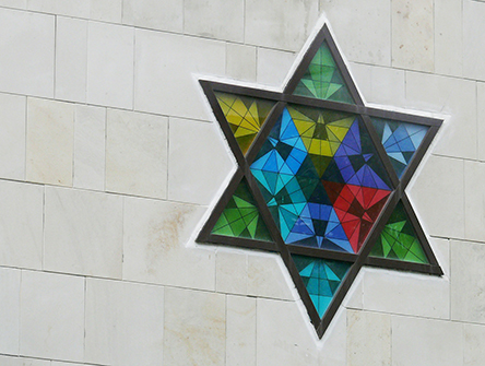 A stain glass window of the Star of David.