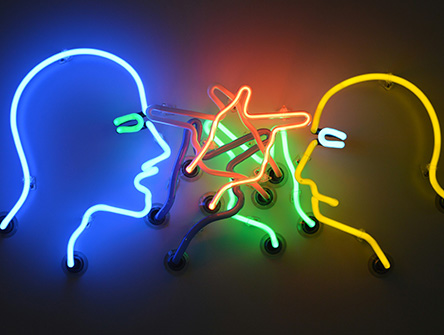 A neon sign of two people arguing. 