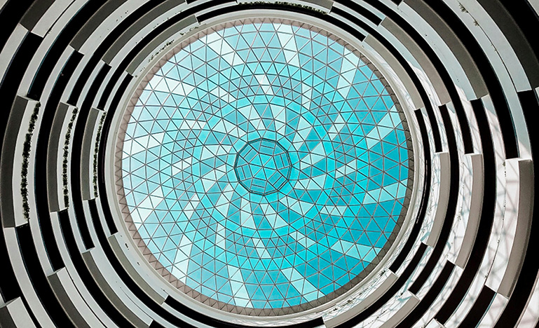 A multi-coloured circle stained glass window.