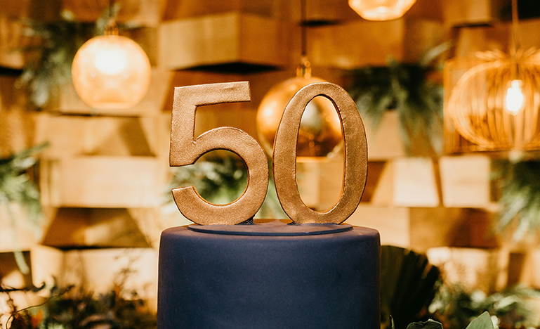 A large "50" figure on top of a podium.
