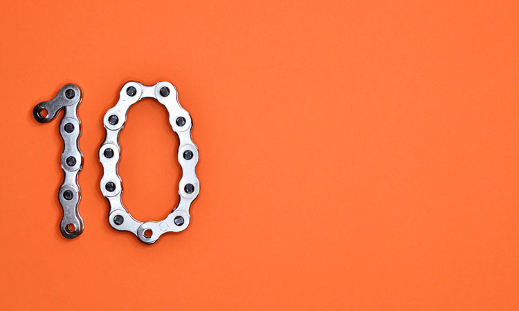 The number 10 formed with a bicycle chain on an orange background