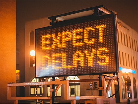 A road work sign that reads "Expect Delays". 