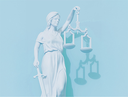 The goddess Themis holding the scales of justice and a sword.