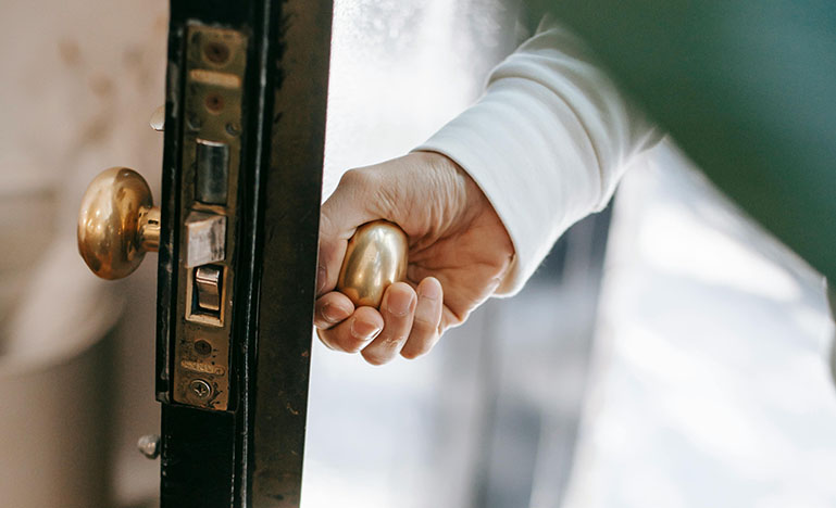 A person opening a door. 