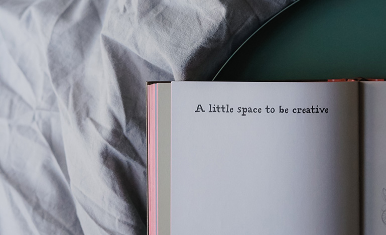 "A little space to be creative" printed in open book.